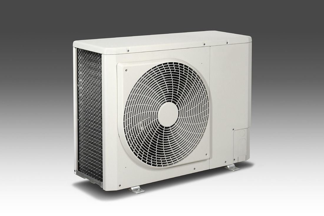Outdoor HVAC condenser unit installed by Axiom Heating and Air Conditioning